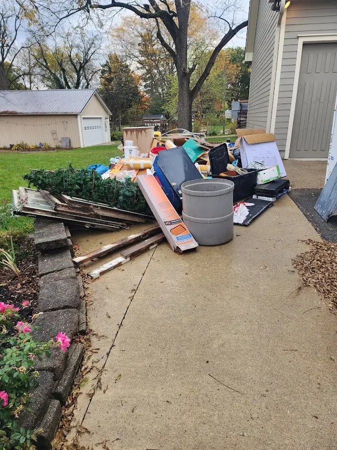 Dumpster being loaded with debris for Commercial Dumpster Rental in Rockford